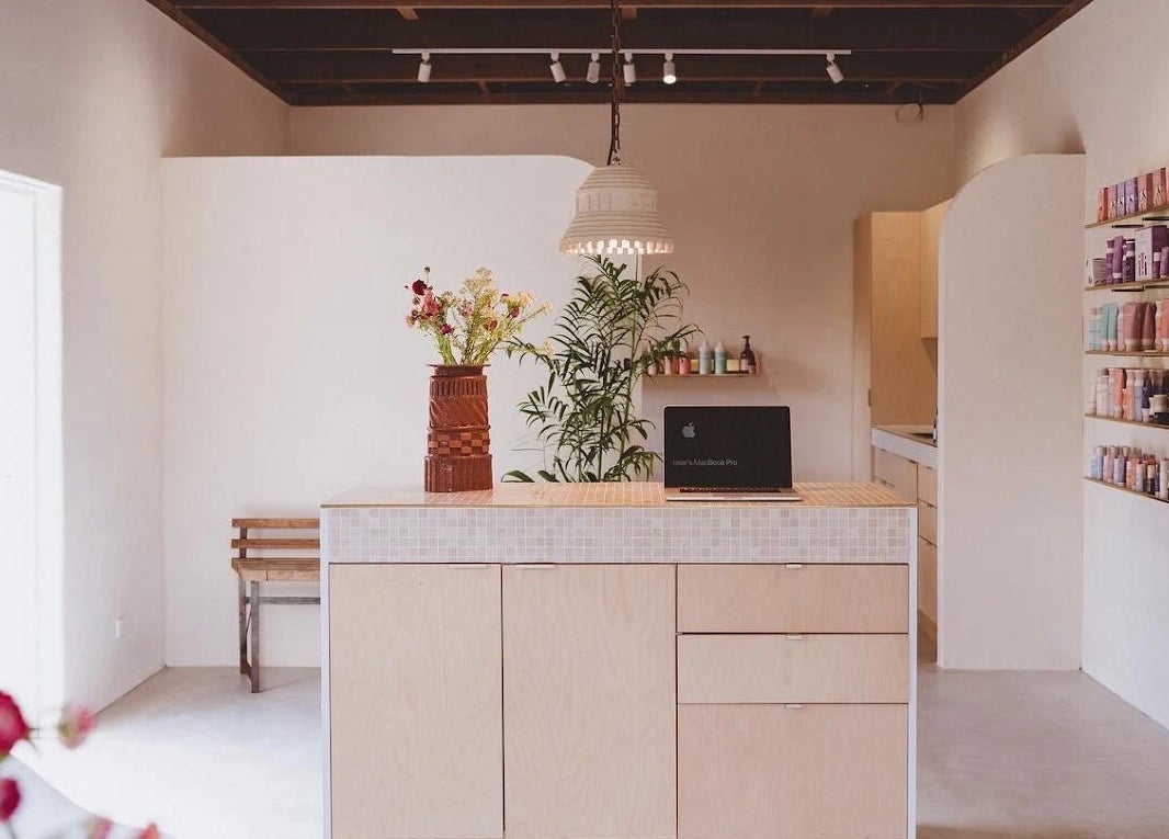 Modern reception at Baby Jane Hair in Bellingen, New South Wales, AU with stylish decor and beauty products.