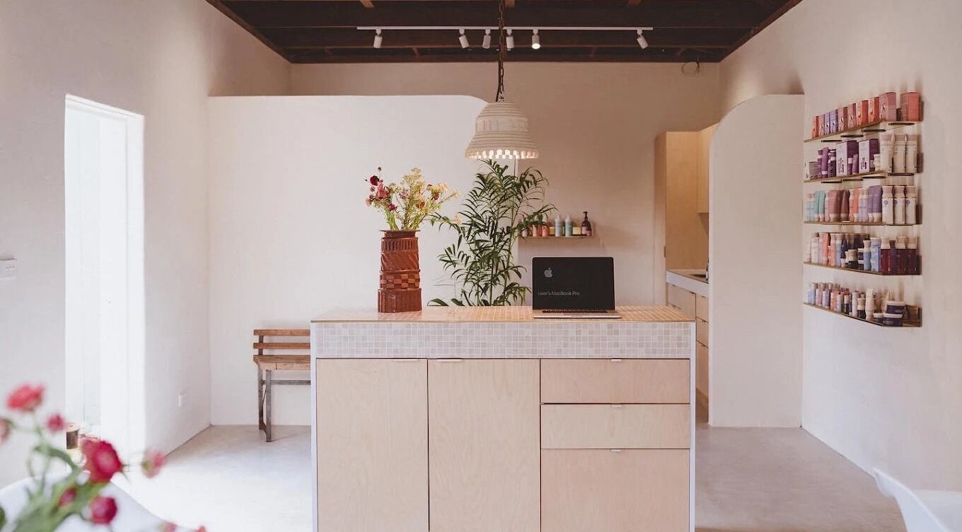 Modern reception at Baby Jane Hair in Bellingen, New South Wales, AU with stylish decor and beauty products.