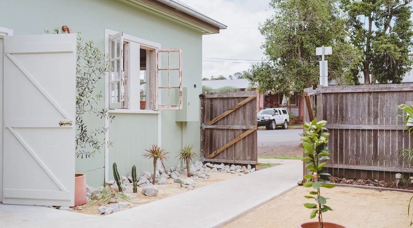 Charming outdoor entrance of Baby Jane hair in Bellingen, New South Wales, AU, featuring rustic doors and greenery.