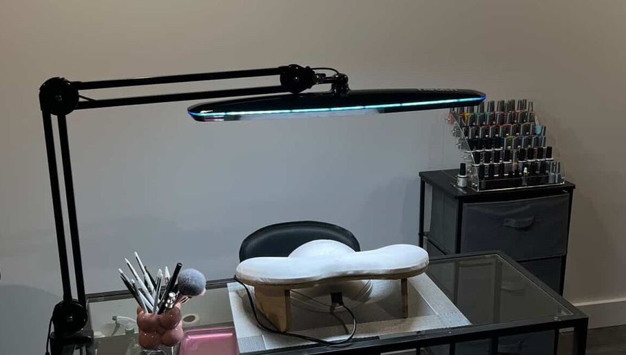 Elegant nail station at Maison Ébène, Montréal, Québec, CA showcasing tools and polish under sleek lighting.