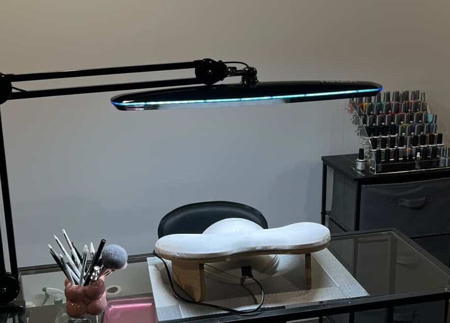 Elegant nail station at Maison Ébène, Montréal, Québec, CA showcasing tools and polish under sleek lighting.