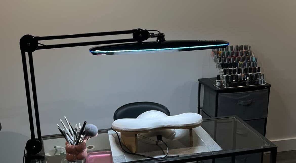 Elegant nail station at Maison Ébène, Montréal, Québec, CA showcasing tools and polish under sleek lighting.