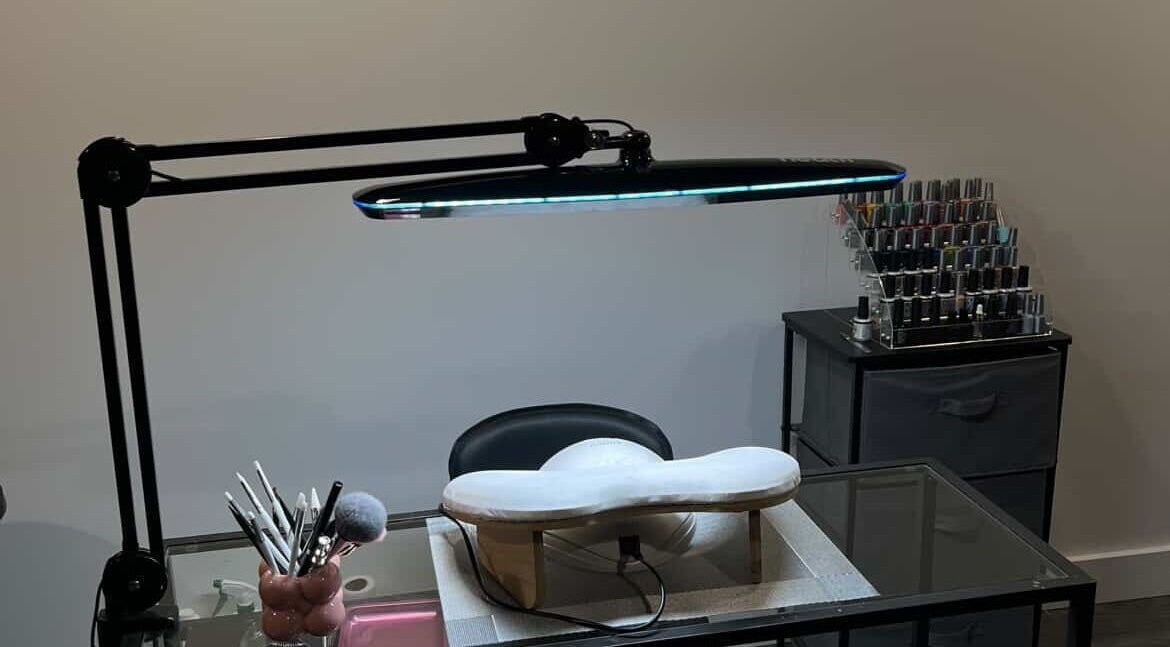 Elegant nail station at Maison Ébène, Montréal, Québec, CA showcasing tools and polish under sleek lighting.