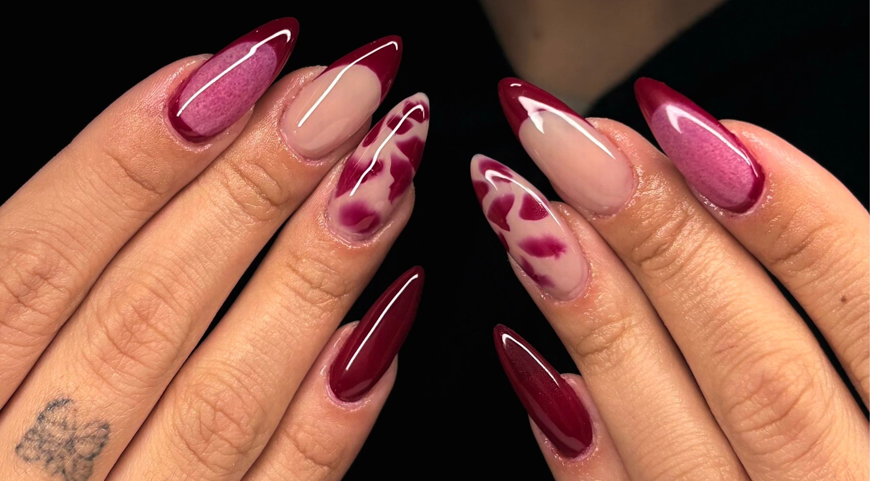Elegant crimson nail art from Maison Ébène, Montréal, Québec, CA, showcasing intricate design.