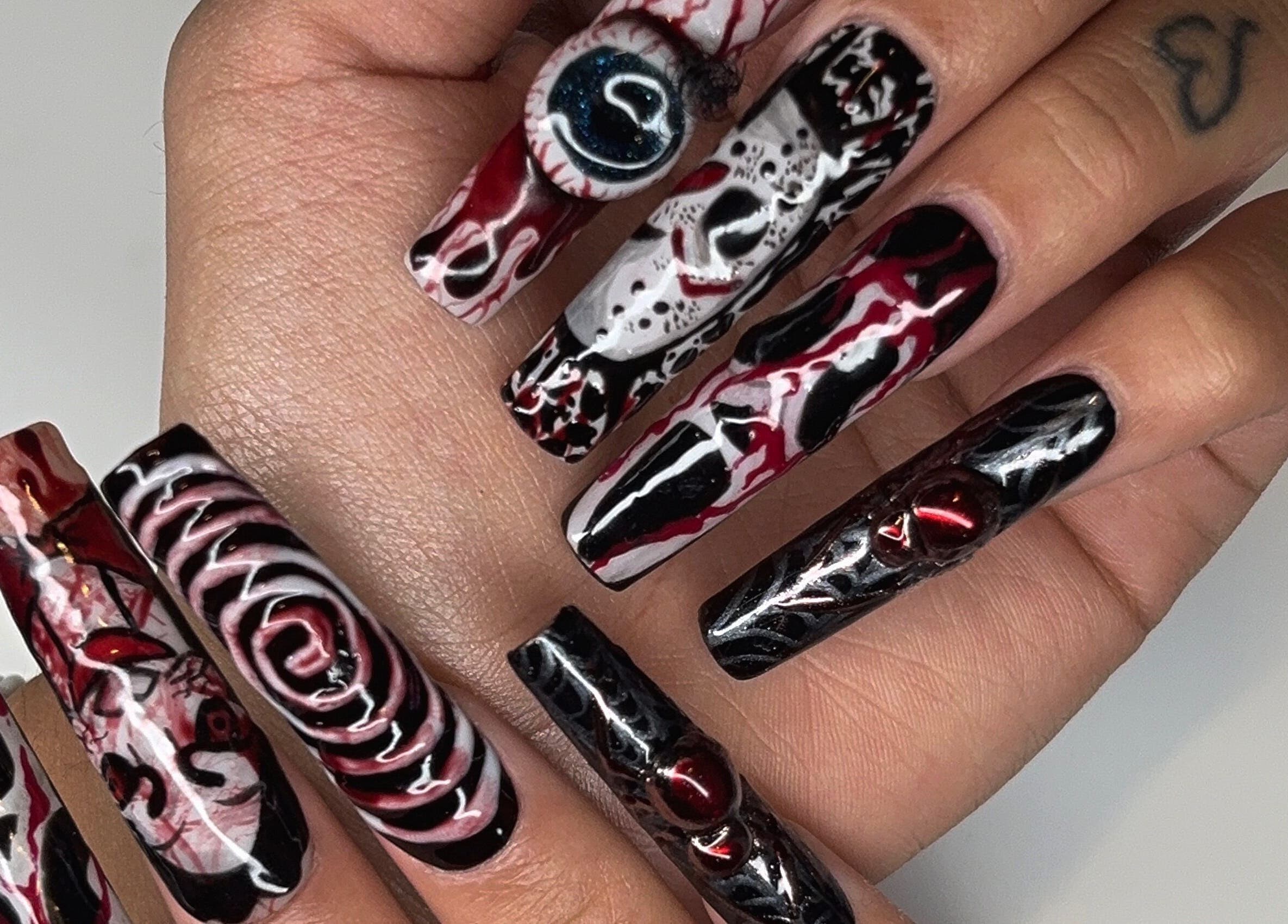 Unique nail art at Maison Ébène, Montréal, Québec, CA showcasing intricate designs on long nails.