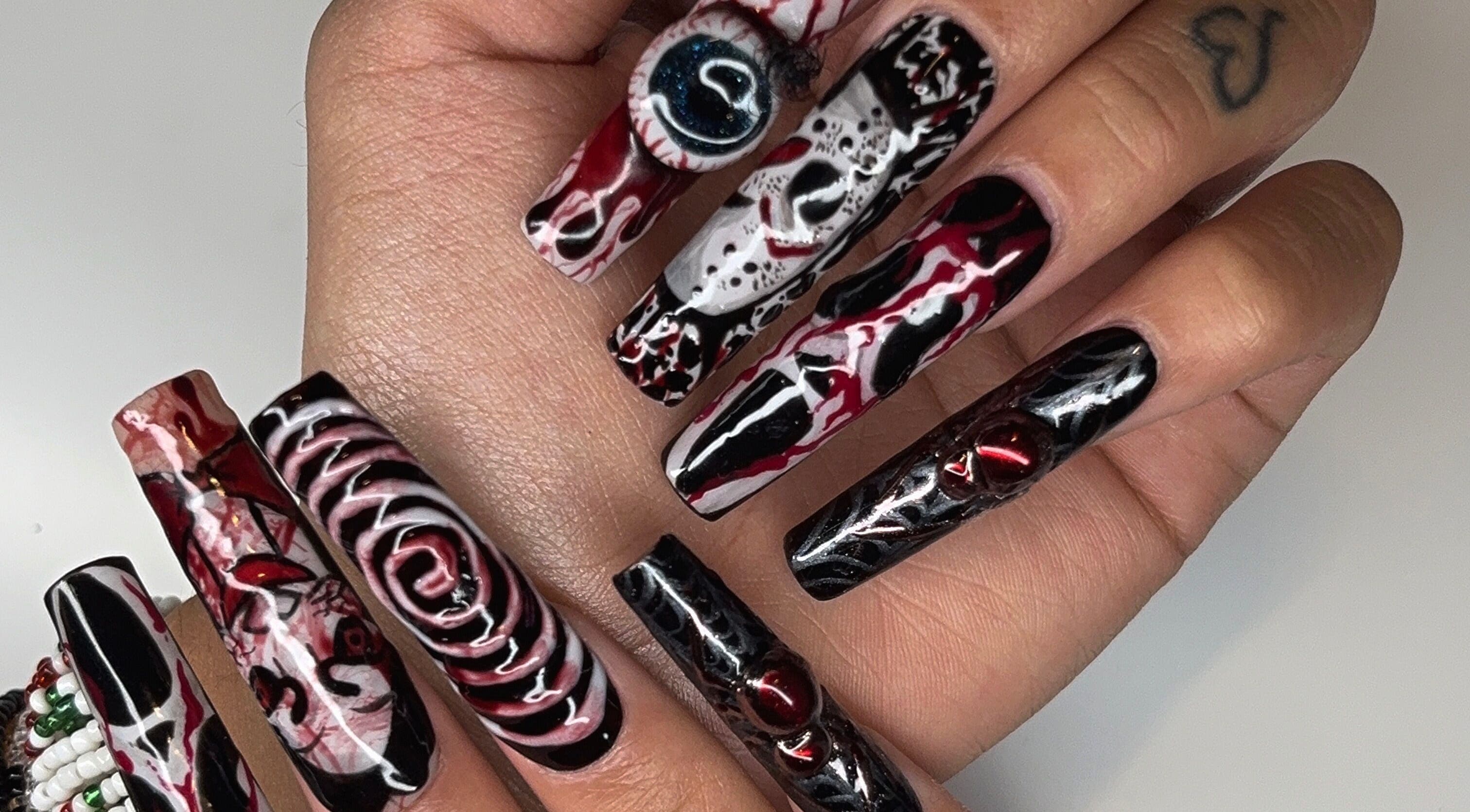 Unique nail art at Maison Ébène, Montréal, Québec, CA showcasing intricate designs on long nails.