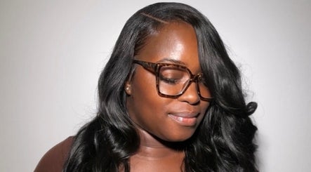Woman with styled hair and glasses at Quori B. Aesthetics, Louisville, Kentucky, US.