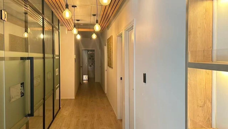 Warm-lit corridor at NM MEDSPA, Auckland, Auckland, NZ showcasing sleek modern design and inviting ambiance.
