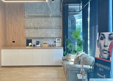 Bright, modern lounge at NM MEDSPA in Auckland, NZ with a cozy sofa and elegant decor.