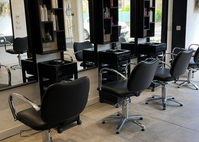 Interior of Hair By Kendal, Gourock, Scotland, GB, showcasing sleek styling chairs and mirrors in a modern salon.