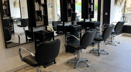 Interior of Hair By Kendal, Gourock, Scotland, GB, showcasing sleek styling chairs and mirrors in a modern salon.