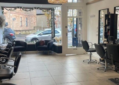 Modern salon interior at Hair By Kendal, Gourock, Scotland, GB showcasing chic chairs and elegant decor.