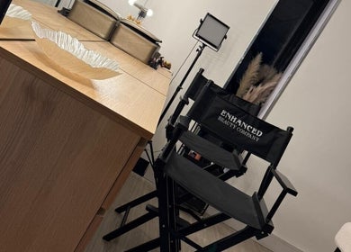 Chic makeup station at ES Beauty, Aberdare, Wales, GB, featuring stylish chairs and a large mirror.