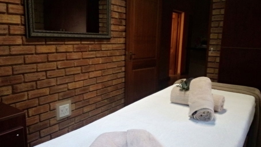 Tranquil massage room at Getnailed, Randburg, Gauteng, ZA with cozy towels on table.