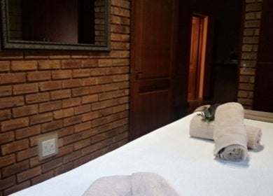 Tranquil massage room at Getnailed, Randburg, Gauteng, ZA with cozy towels on table.