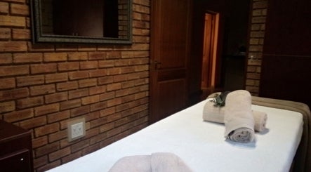 Tranquil massage room at Getnailed, Randburg, Gauteng, ZA with cozy towels on table.