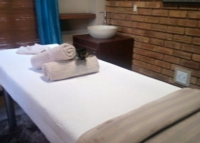 Relaxing massage table setup at Getnailed, Randburg, Gauteng, ZA, with soft towels and serene ambiance.