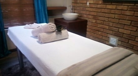 Relaxing massage table setup at Getnailed, Randburg, Gauteng, ZA, with soft towels and serene ambiance.