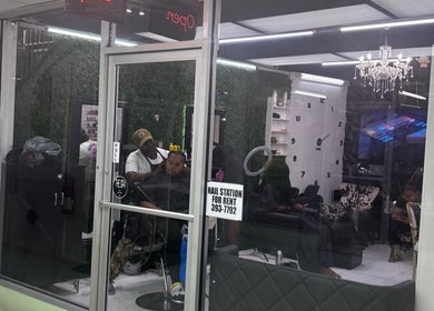 Ariacrylics salon in Arima offers chic interiors with stylish decor, visible through glass doors.