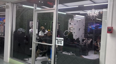 Ariacrylics salon in Arima offers chic interiors with stylish decor, visible through glass doors.