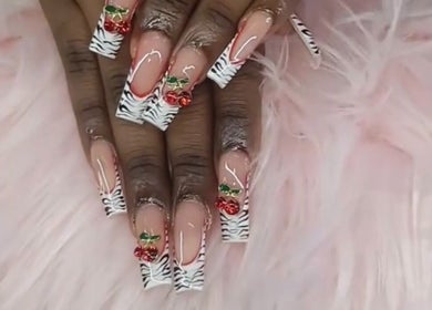 Chic zebra and cherry nail art at Rashelle Hair Nails and More, May Pen, Clarendon, JM on fluffy pink background.