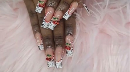 Chic zebra and cherry nail art at Rashelle Hair Nails and More, May Pen, Clarendon, JM on fluffy pink background.