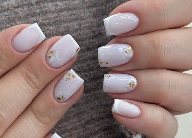Elegant white and gold nail art from Afa Studio, Dublin, County Dublin, IE, showcasing intricate designs.