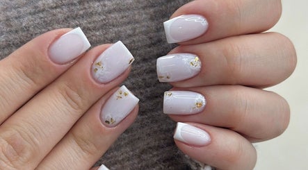 Elegant white and gold nail art from Afa Studio, Dublin, County Dublin, IE, showcasing intricate designs.