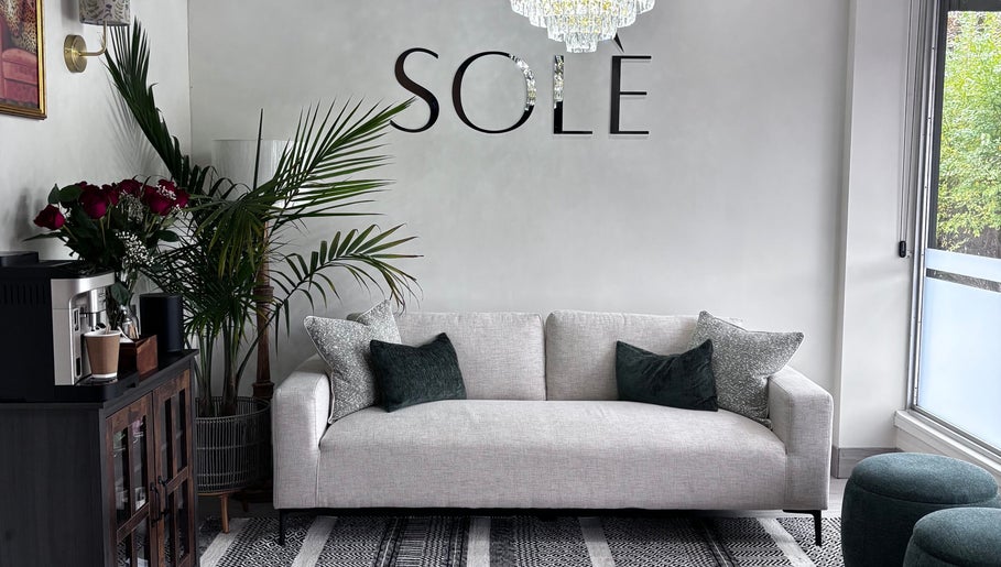 Sleek sofa and decor at Solé Beauty Lounge in London, Ontario, CA offers an inviting ambiance for relaxation.