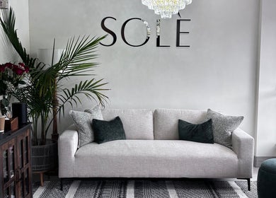 Sleek sofa and decor at Solé Beauty Lounge in London, Ontario, CA offers an inviting ambiance for relaxation.