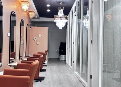 Interior of Solé Beauty Lounge in London, Ontario, CA with chic seating and elegant chandeliers.