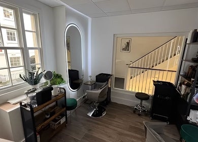 Inside view of Na.Ko Hair London, a chic salon space in London, England, GB with modern decor and natural light.