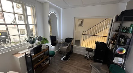 Inside view of Na.Ko Hair London, a chic salon space in London, England, GB with modern decor and natural light.