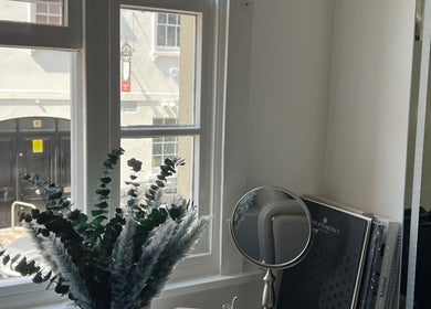 Interior view with mirror and plant at Na.Ko Hair London, showcasing natural light in London, England, GB.