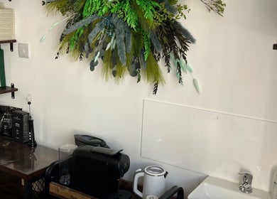 Stylish hair salon corner at Na.Ko Hair London, featuring greenery and products in London, England, GB.