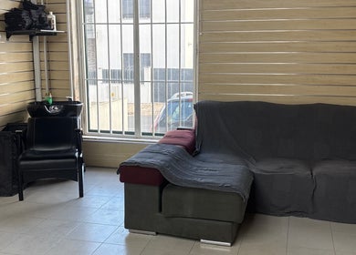 Comfortable seating and hair washing station at Prestígio, Ramada, Lisboa, PT, offering relaxation and style.