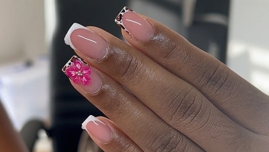 Elegant nail art with a pink floral design at TheNailLab, Belvedere, SX.