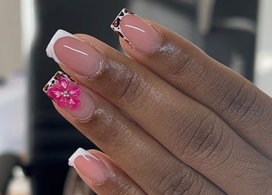 Elegant nail art with a pink floral design at TheNailLab, Belvedere, SX.