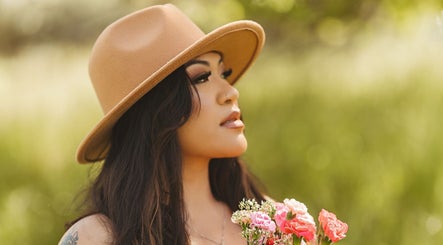 Person in hat with flowers at Oak Soul Collective, Oakland, California, US.