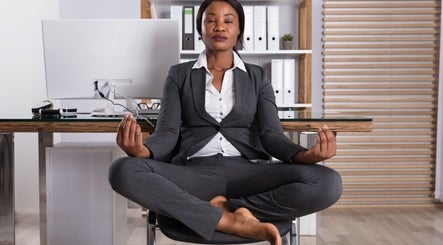 Professional meditating at Oak Soul Collective, Oakland, California, US, promoting workplace wellness.