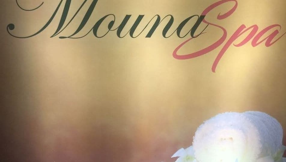 Elegant Mouna Unisex Salon and Spa sign with towels in Arisinakunte, Karnataka, IN.