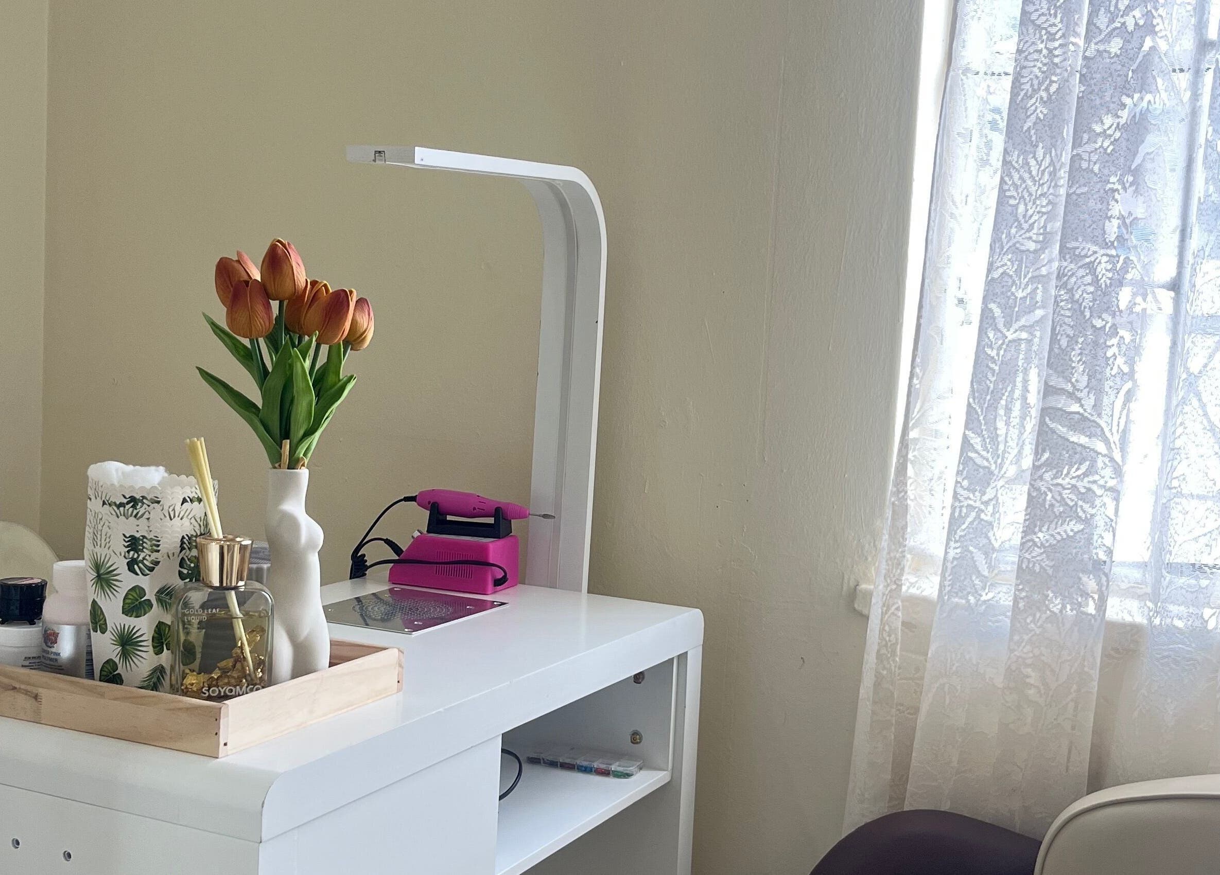 Elegant nail station with tulips at Essentials Lately, Harare, Harare Province, ZW.