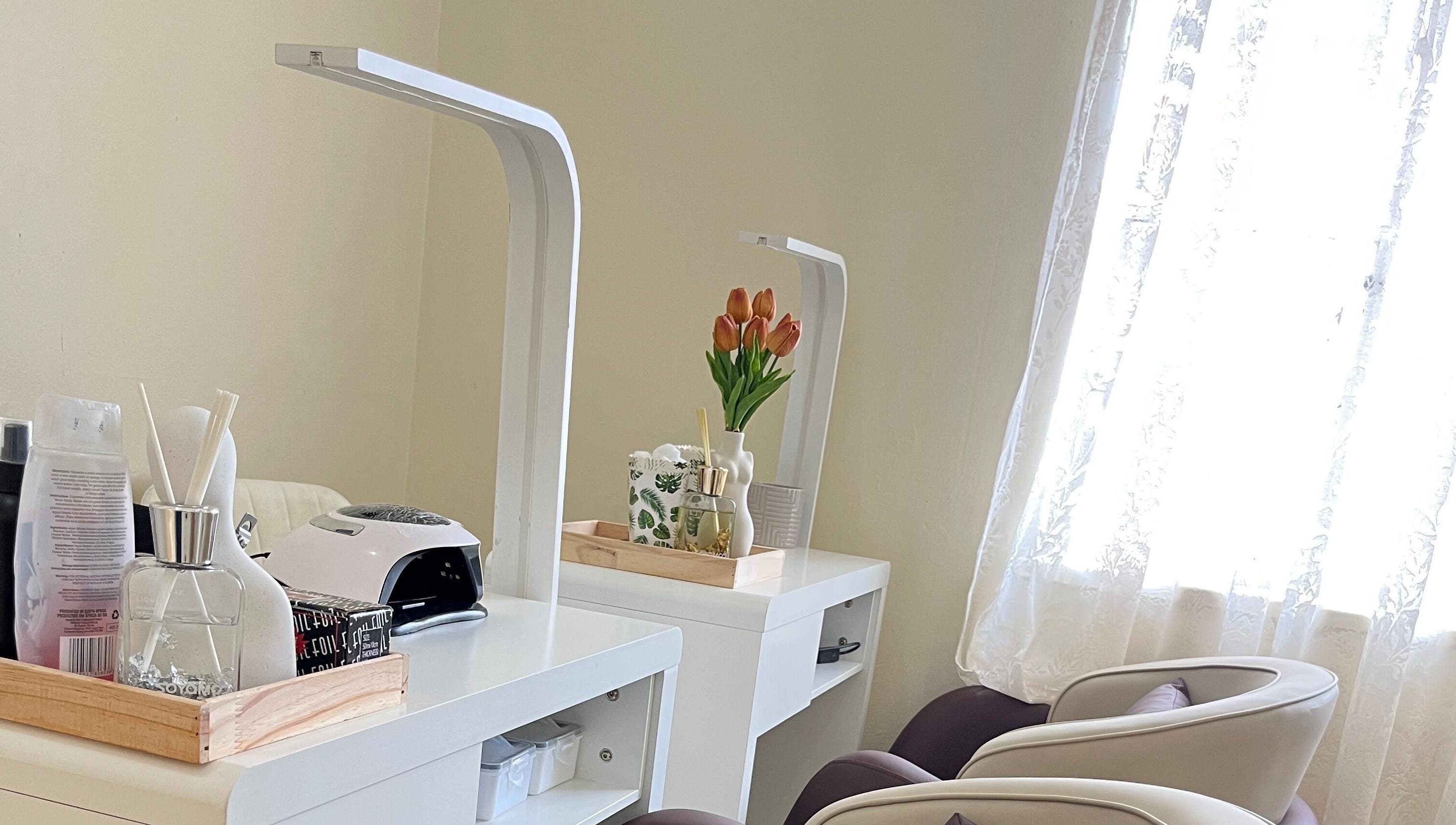 Essentials Lately nail salon setup in Harare, Harare Province, ZW with chairs and manicure station.