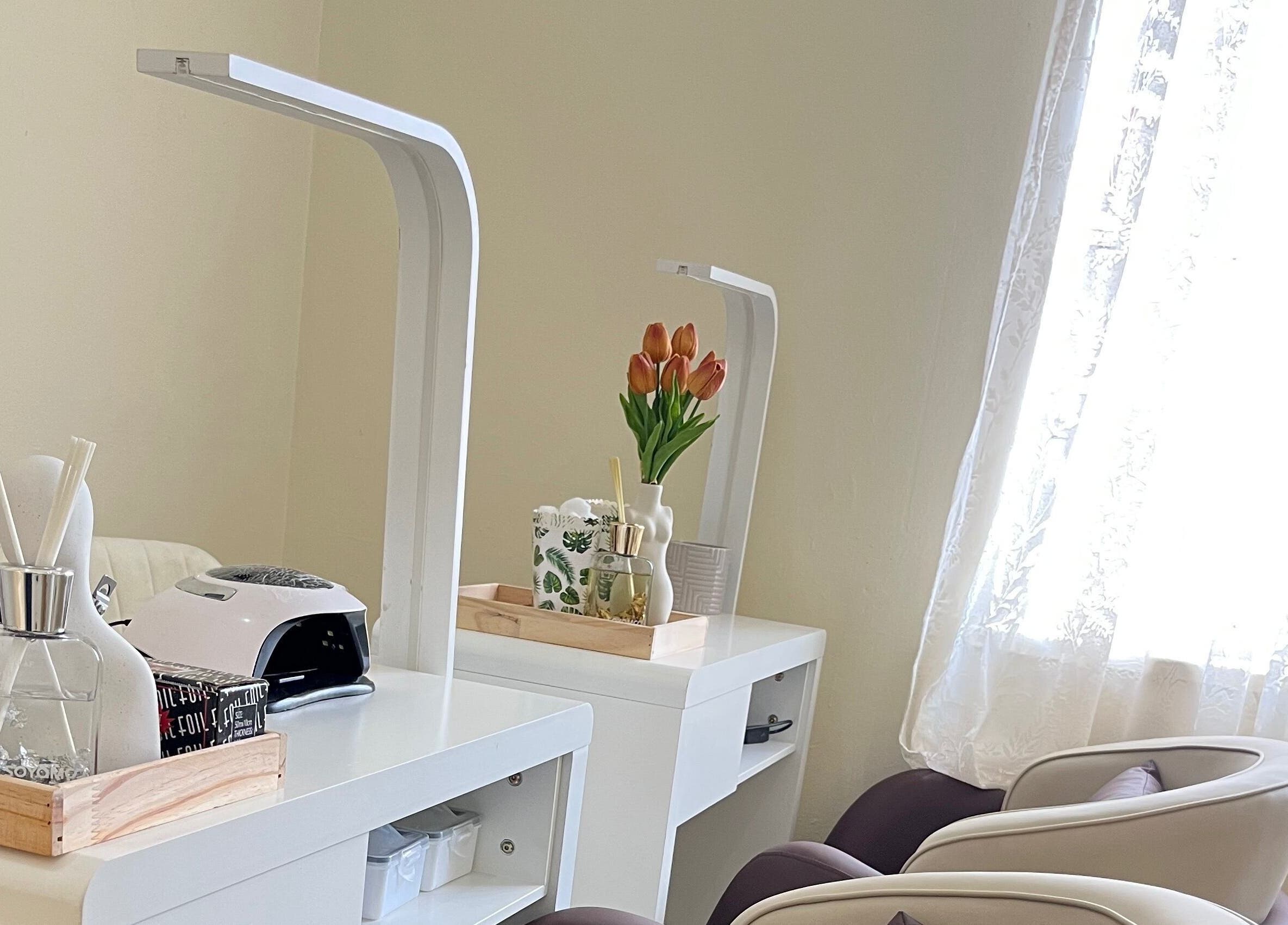 Essentials Lately nail salon setup in Harare, Harare Province, ZW with chairs and manicure station.