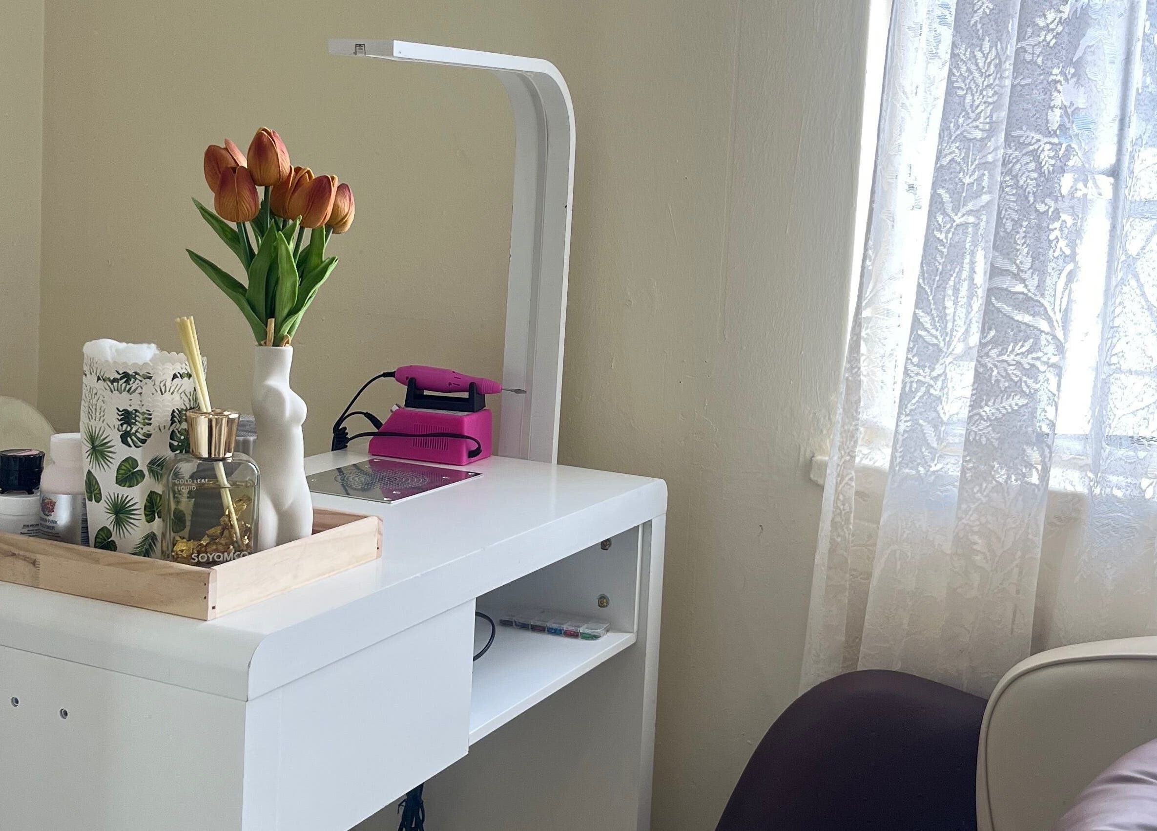 Cozy nail salon corner at Essentials Lately, Harare, Harare Province, ZW with desk and decor.