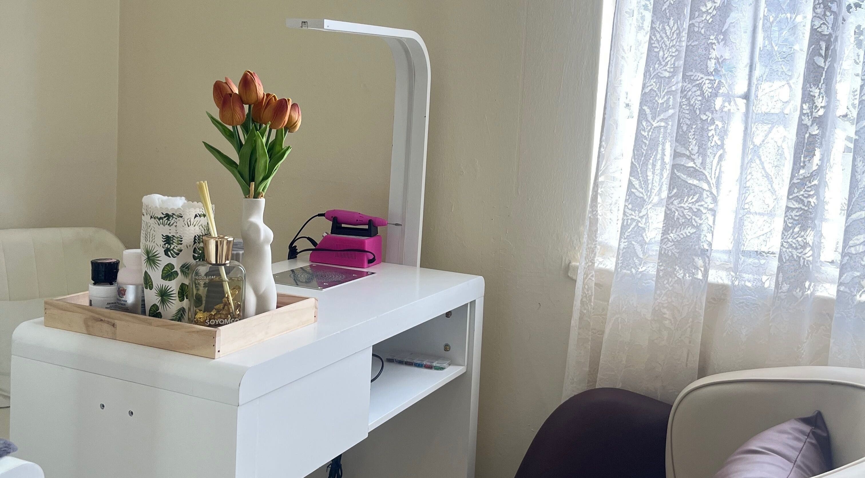 Cozy nail salon corner at Essentials Lately, Harare, Harare Province, ZW with desk and decor.