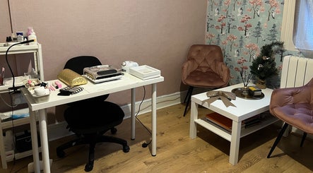 Chic beauty corner at GLAMMY, London, England, GB featuring manicure setup and stylish seating.