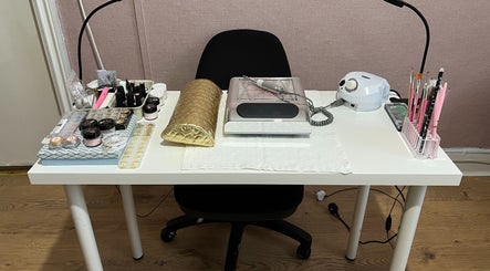 Professional nail studio setup at GLAMMY, London, England, GB, featuring tools and products on a tidy table.