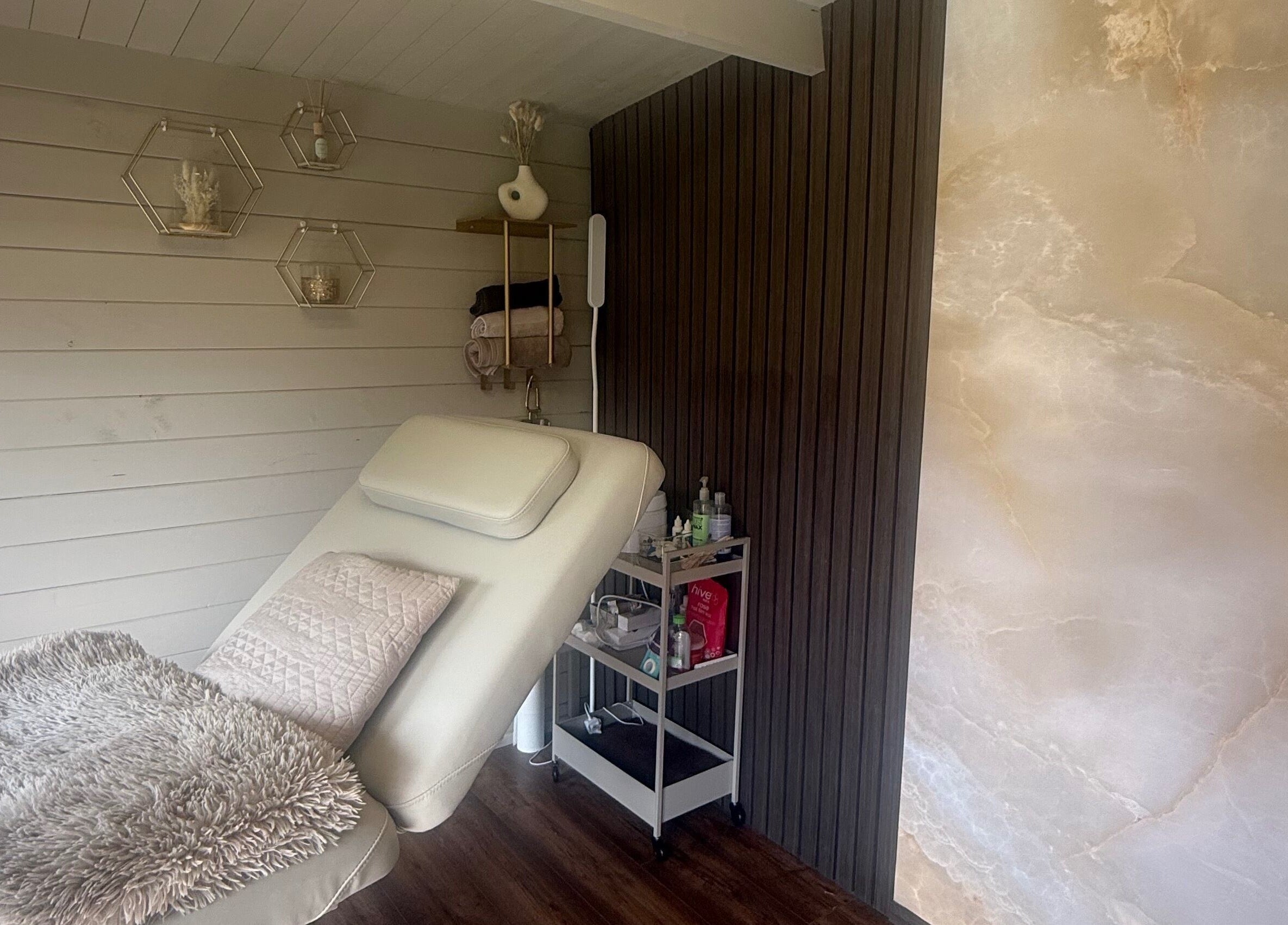 A tranquil treatment room at Ljbeautystudio, Wickford, England, GB, featuring a comfortable chair and modern decor.