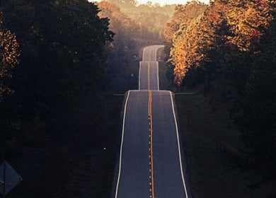 A winding road at sunset near Jenni Moresco Therapy, Baldock, England, GB.